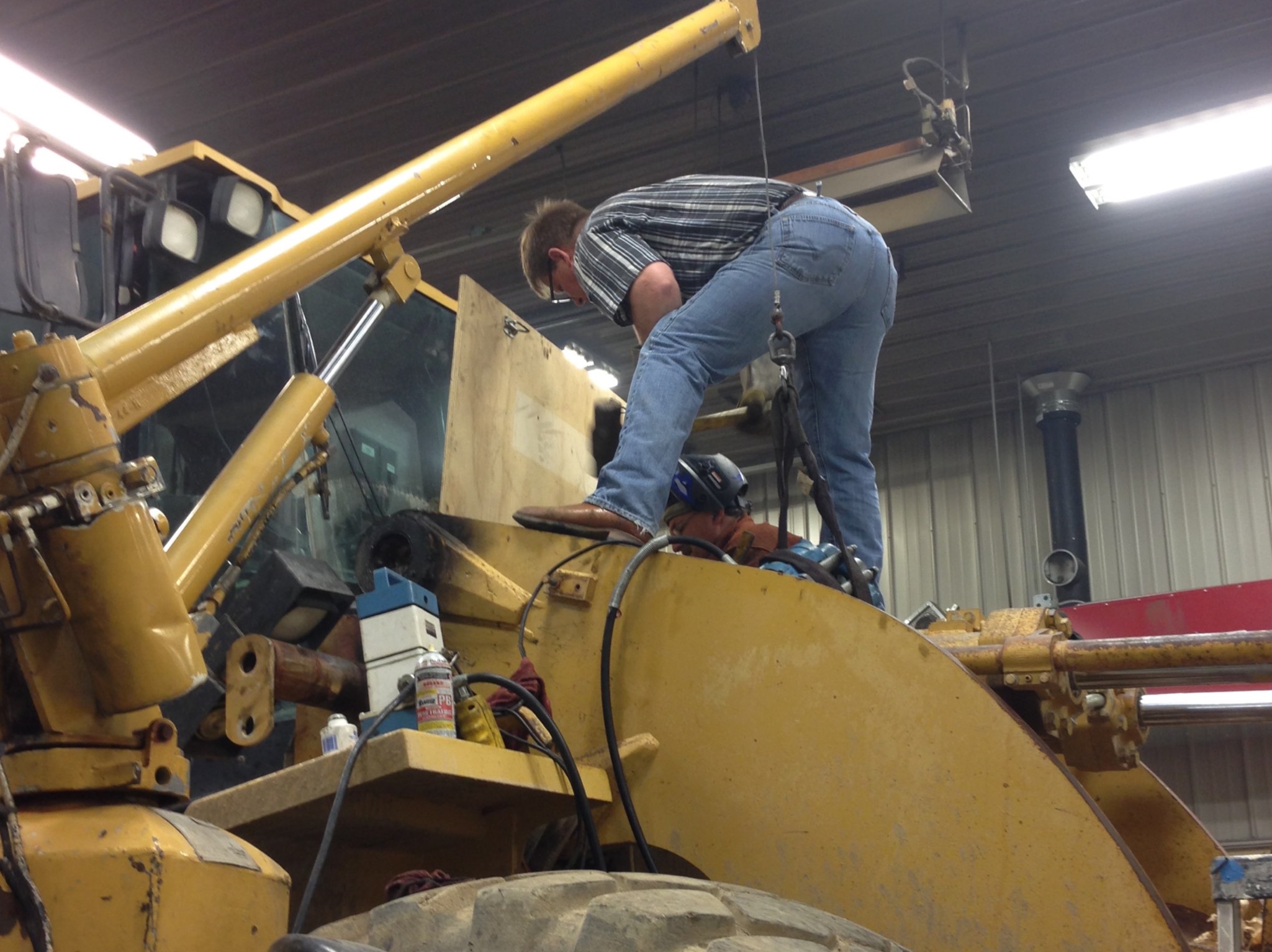 Man repairing a tractor